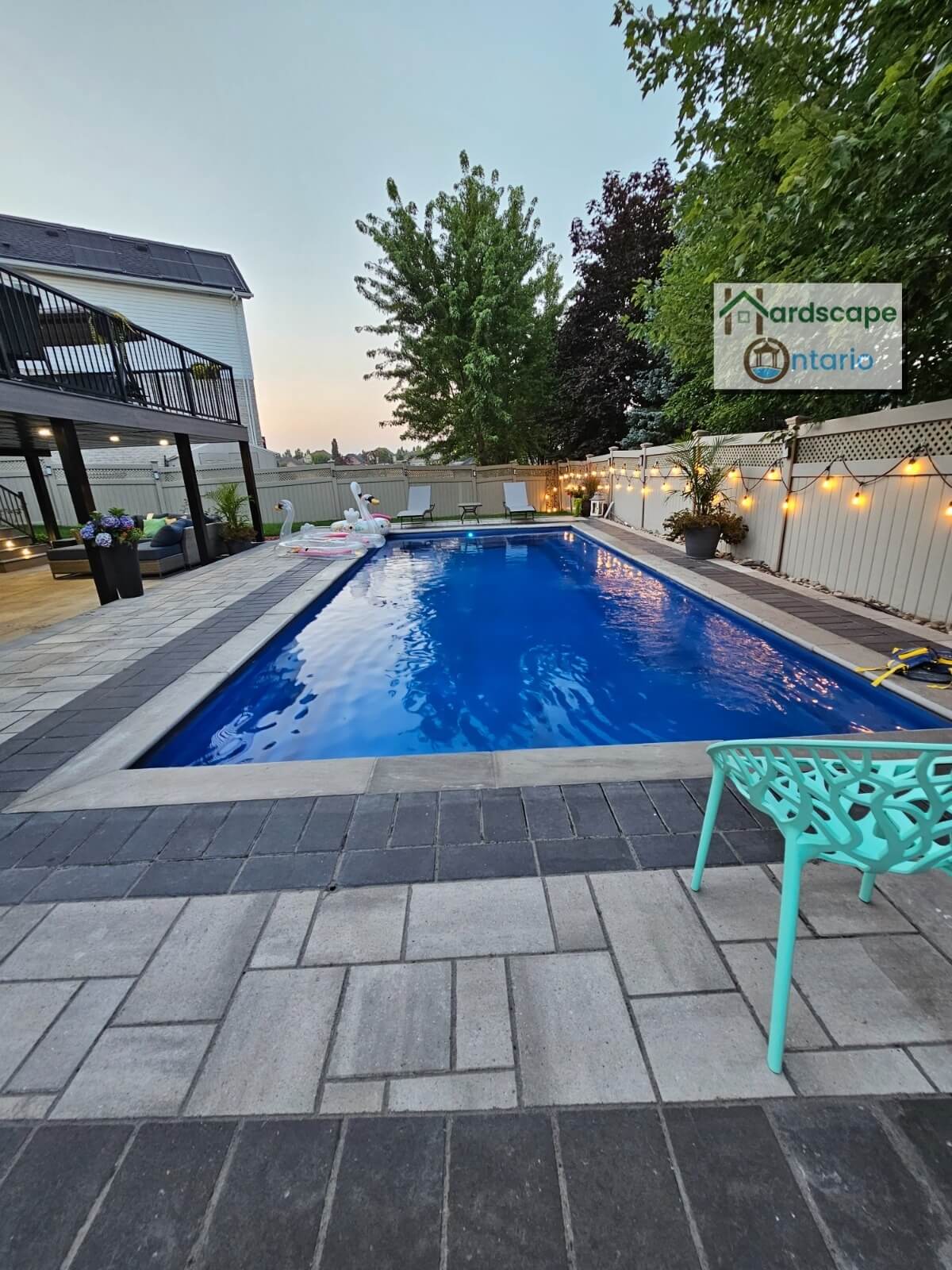 Beautifully designed backyard swimming pool with interlocking surrounding